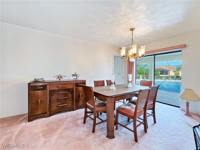 carpeted dining room featuring a notable chandelier and a textured ceiling