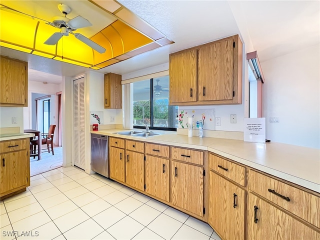 kitchen featuring dishwasher, sink, light tile patterned floors, and ceiling fan