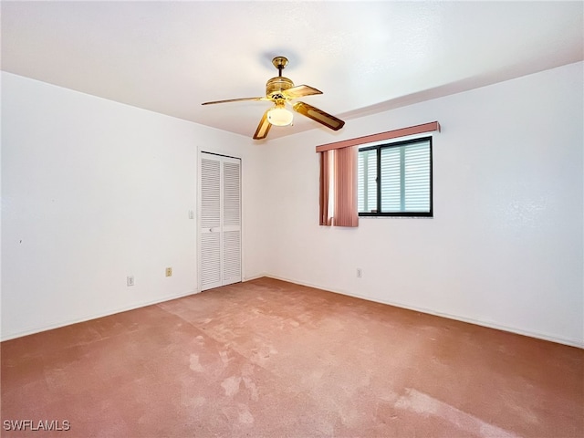 unfurnished room featuring light carpet and ceiling fan