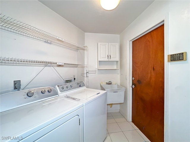 laundry room with sink, washer and clothes dryer, and light tile patterned floors