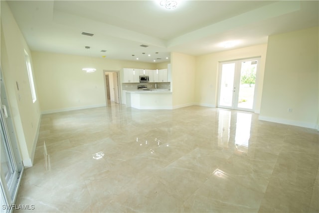 unfurnished living room with sink