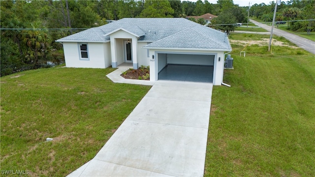 ranch-style home with a garage, a front lawn, and central air condition unit