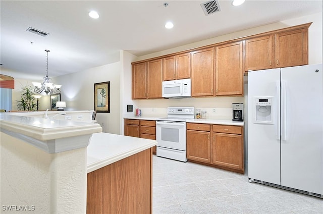 kitchen featuring hanging light fixtures, a center island, white appliances, and a chandelier