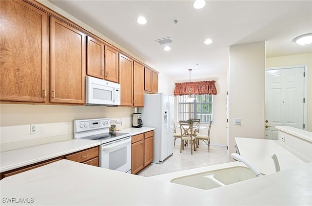 kitchen with sink, decorative light fixtures, white appliances, and light tile patterned flooring