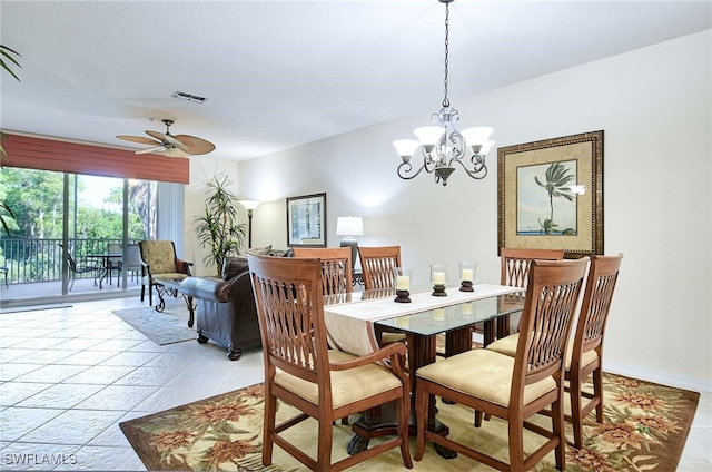 dining room with ceiling fan with notable chandelier and light tile patterned floors