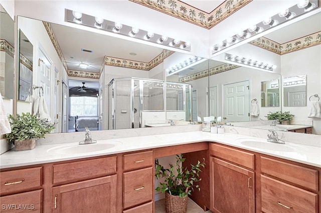 bathroom featuring vanity, ceiling fan, and a shower with door