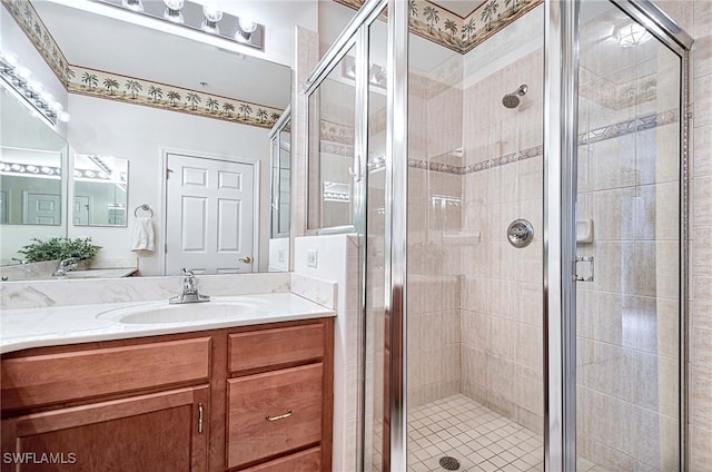 bathroom featuring vanity and an enclosed shower