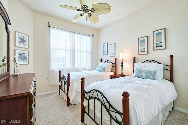 bedroom with ceiling fan and light carpet