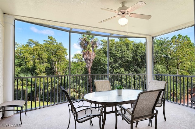 sunroom / solarium featuring ceiling fan and plenty of natural light