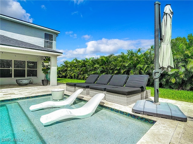 view of swimming pool featuring outdoor lounge area and a patio