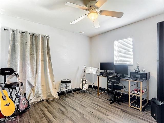 home office featuring wood-type flooring and ceiling fan