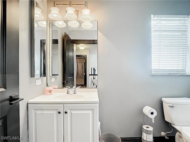 bathroom featuring toilet and vanity