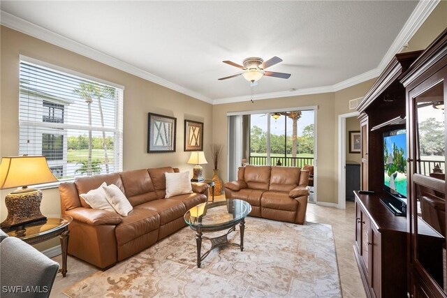 living room with light tile patterned floors, ceiling fan, a wealth of natural light, and ornamental molding