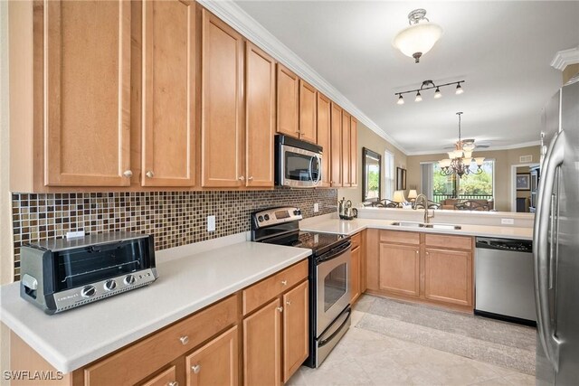 kitchen with light tile patterned floors, appliances with stainless steel finishes, crown molding, kitchen peninsula, and sink