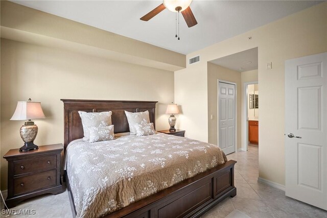 bedroom featuring a closet, ceiling fan, and light tile patterned floors