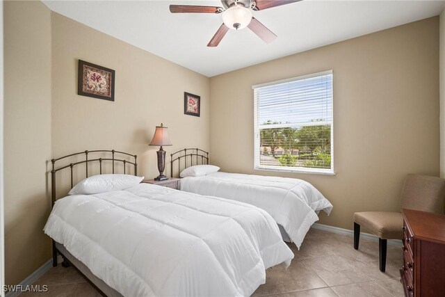 tiled bedroom featuring ceiling fan