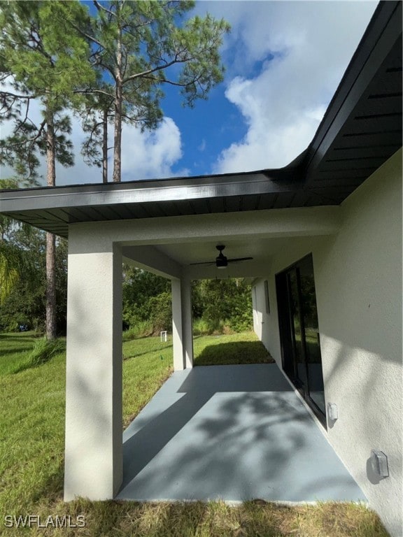 view of parking with a yard and ceiling fan