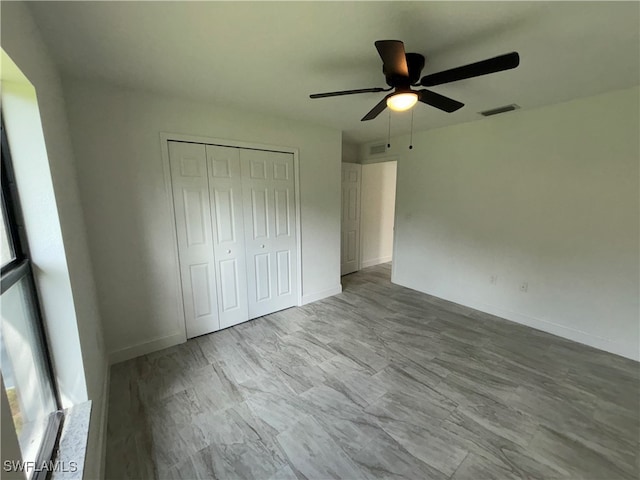 unfurnished bedroom with a closet and ceiling fan