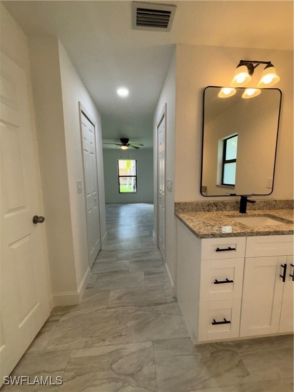 bathroom with vanity and ceiling fan