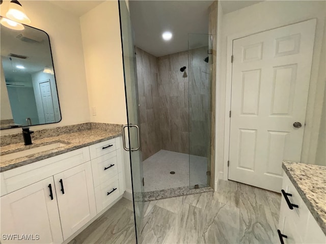 bathroom featuring vanity and an enclosed shower