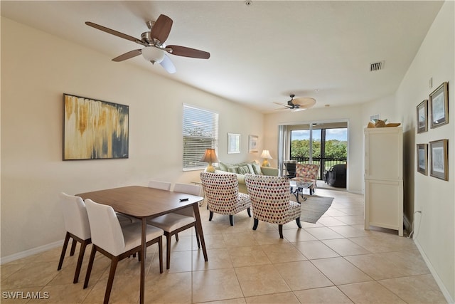 dining space with light tile patterned flooring and ceiling fan