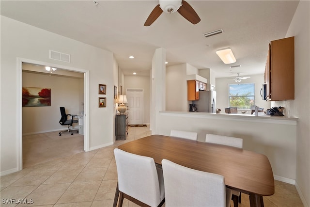 tiled dining room featuring ceiling fan