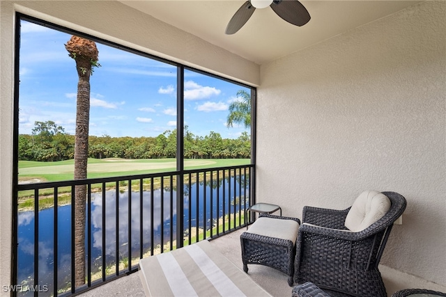 sunroom / solarium with a water view and ceiling fan