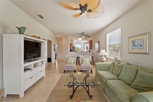 tiled living room featuring ceiling fan