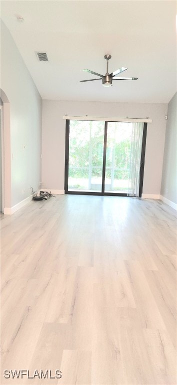 spare room with ceiling fan and light wood-type flooring