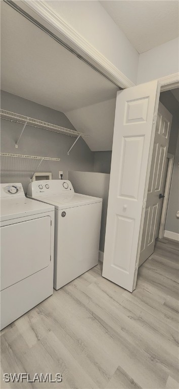 laundry room with light hardwood / wood-style floors and separate washer and dryer