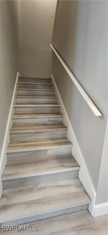 stairway featuring hardwood / wood-style flooring