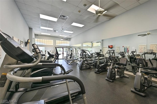 gym with a drop ceiling and ceiling fan