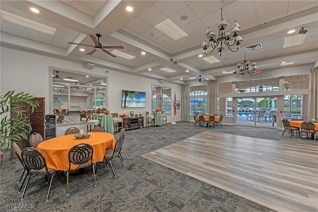 interior space featuring ceiling fan with notable chandelier and hardwood / wood-style flooring