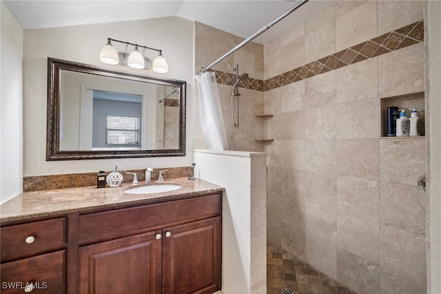 bathroom with lofted ceiling, vanity, and a shower with shower curtain