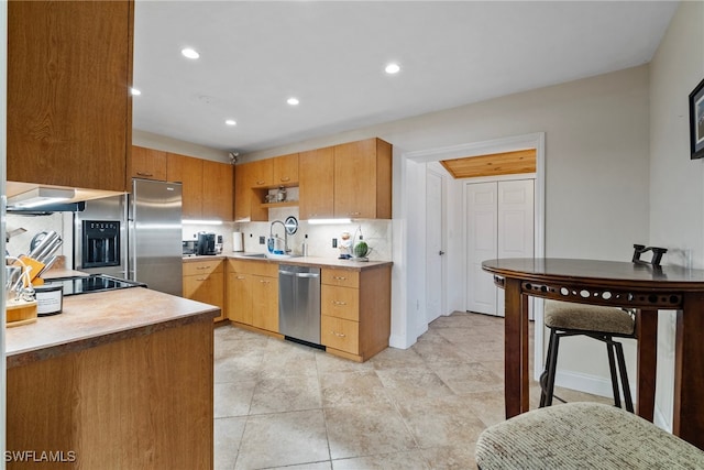 kitchen featuring light tile patterned floors, dishwasher, sink, extractor fan, and tasteful backsplash