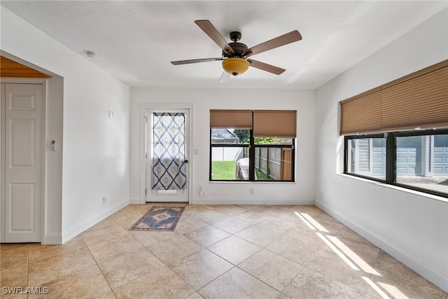 tiled foyer with ceiling fan