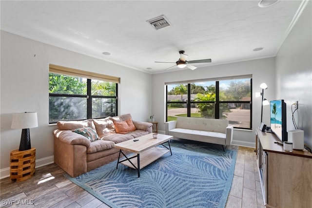 living room featuring hardwood / wood-style floors, ceiling fan, and ornamental molding