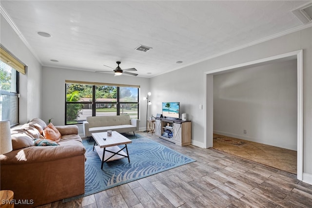 living room featuring plenty of natural light, ceiling fan, ornamental molding, and hardwood / wood-style floors