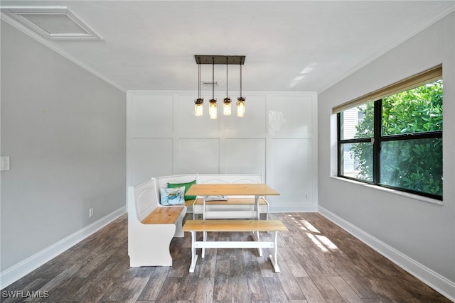 dining room with ornamental molding and dark hardwood / wood-style flooring