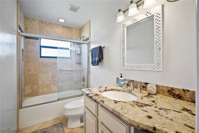 full bathroom with shower / bath combination with glass door, vanity, toilet, and tile patterned floors