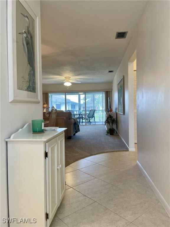 hall featuring light tile patterned floors