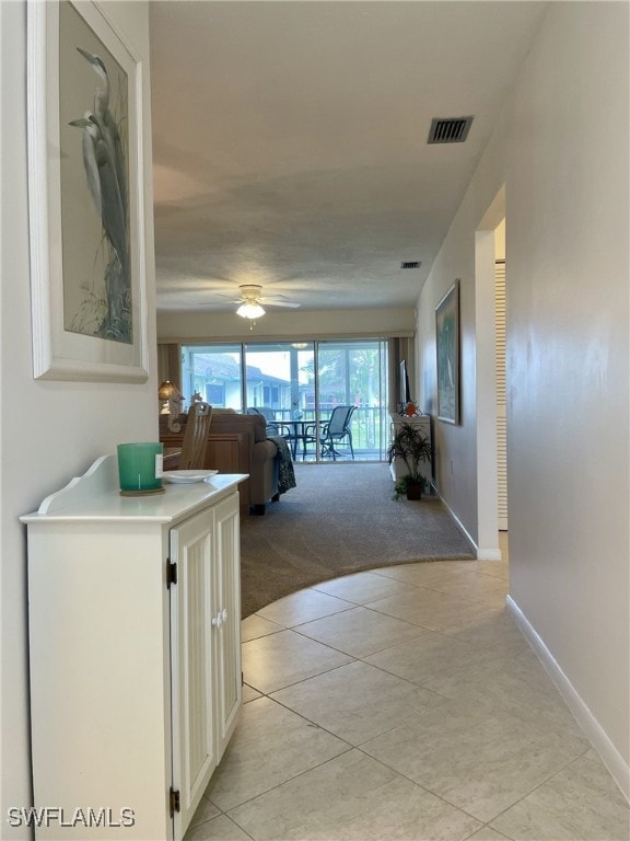 325 Charlemagne Blvd Unit B208, Naples, FL 34112 - corridor featuring light tile patterned floors, baseboards, and light carpet