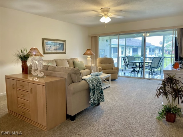 living room with ceiling fan and light colored carpet