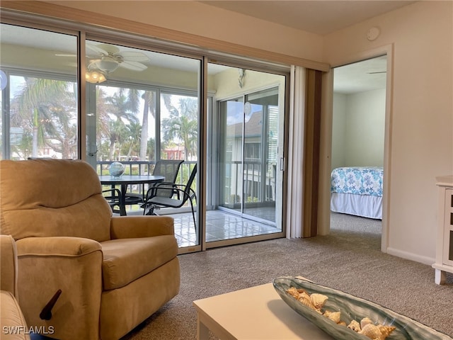 interior space with a wealth of natural light, carpet, and ceiling fan