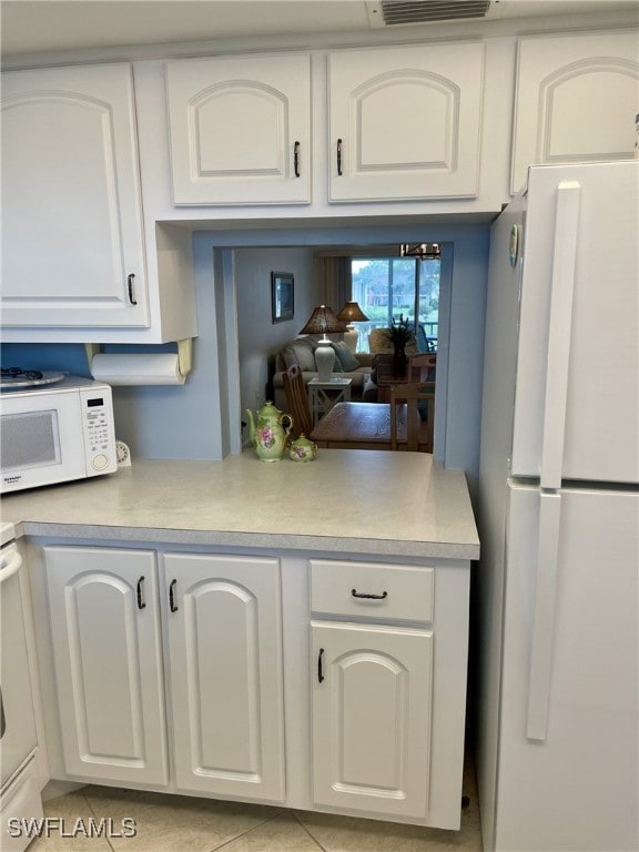 325 Charlemagne Blvd Unit B208, Naples, FL 34112 - kitchen with white appliances, white cabinetry, light countertops, and a peninsula