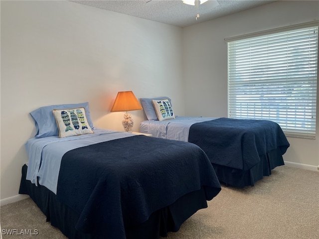 bedroom with light carpet, a textured ceiling, and ceiling fan