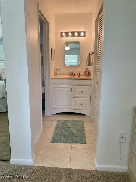 325 Charlemagne Blvd Unit B208, Naples, FL 34112 - bathroom featuring a closet, vanity, tile patterned floors, and baseboards