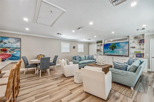 living room featuring crown molding and light hardwood / wood-style flooring