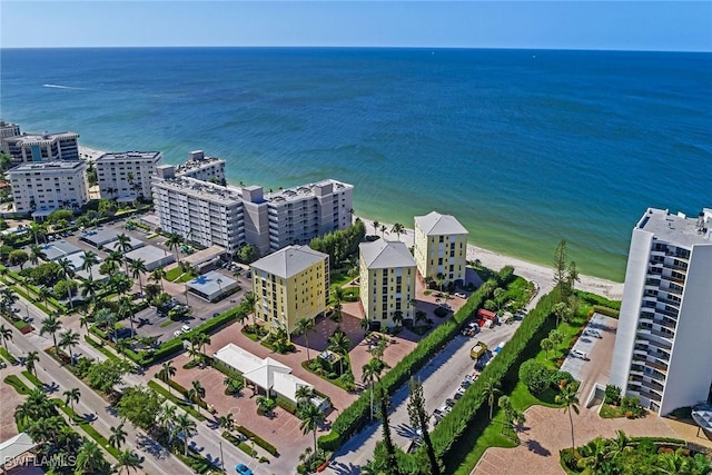 drone / aerial view featuring a water view and a view of the beach