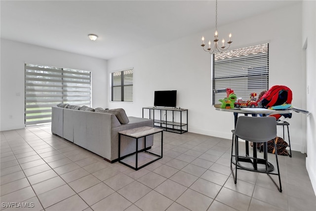 tiled living room featuring a notable chandelier